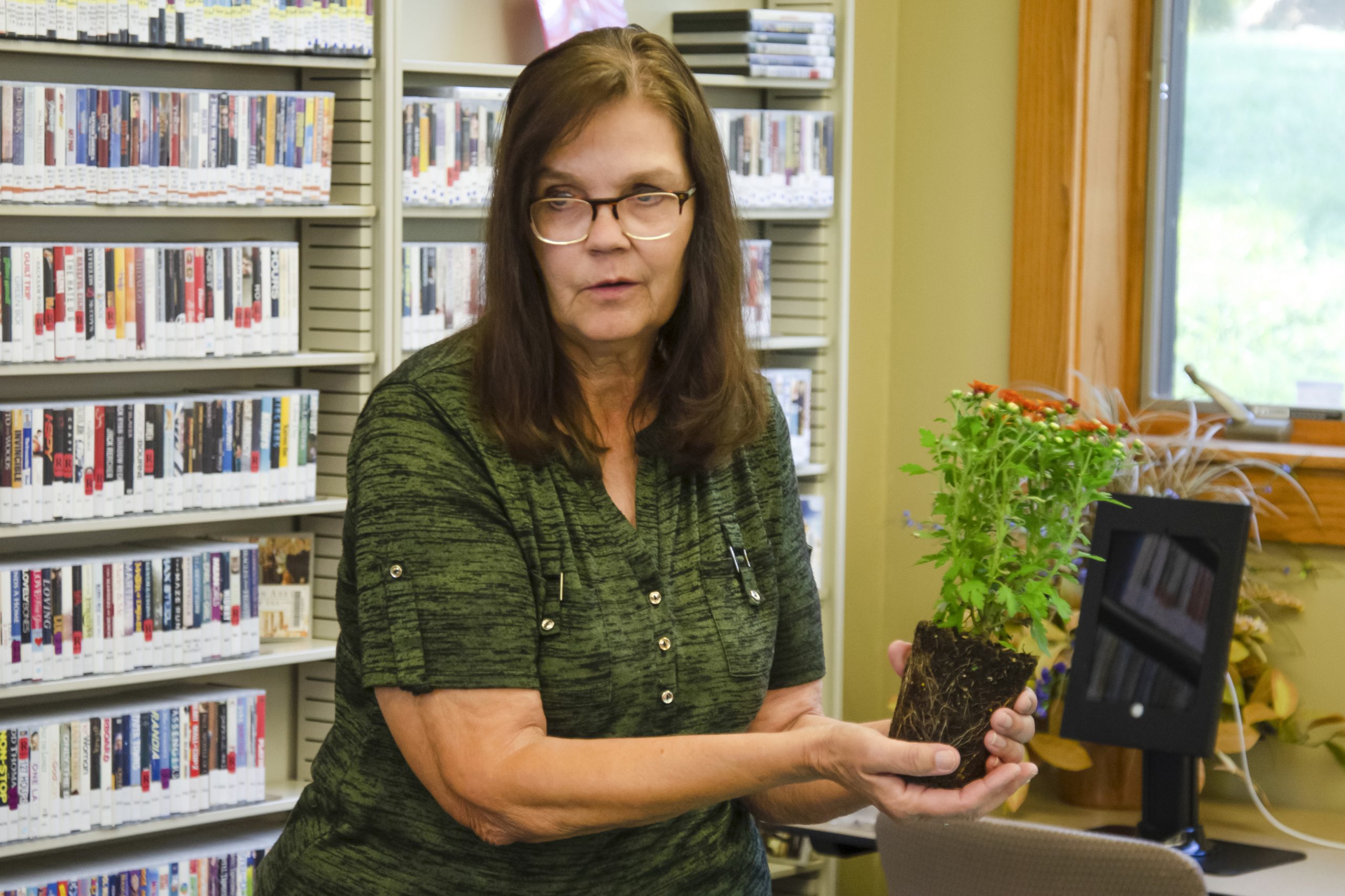 Jane Jenkins removes a succulent from its original pot to demonstrate the importance of soil quality, particularly the need for drainage in the plant’s new environment.